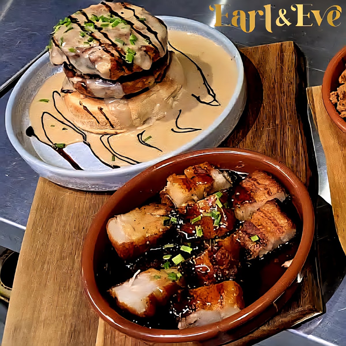 Pork belly bites and a dish in cream sauce at Earl & Eve