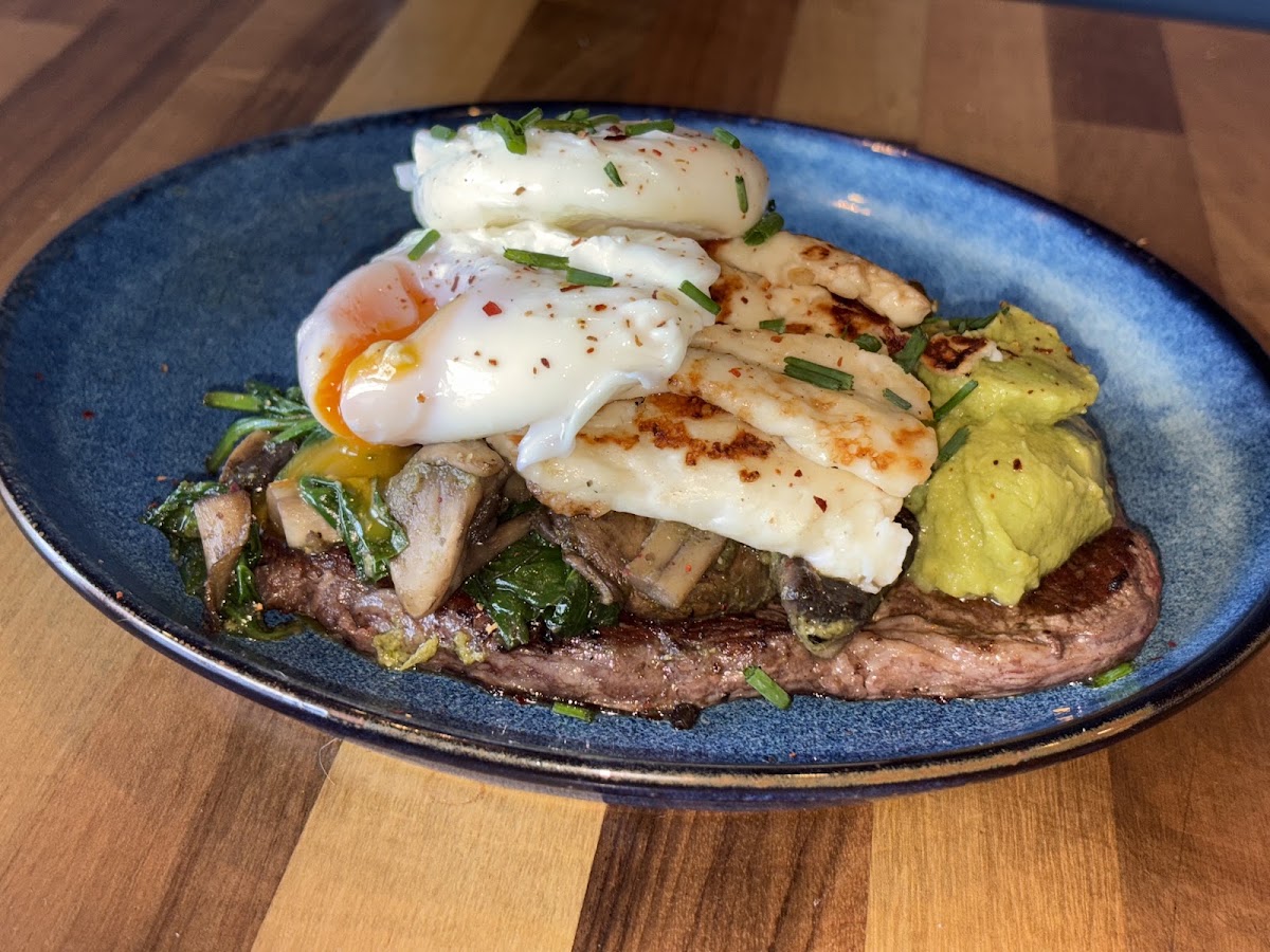 Steak with poached eggs, halloumi and avocado at Earl & Eve